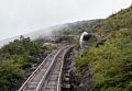 A face in the rock highlighted against a white backdrop.<br />Aug. 22, 2014 - Cog Railway, Mount Washington, New Hampshire