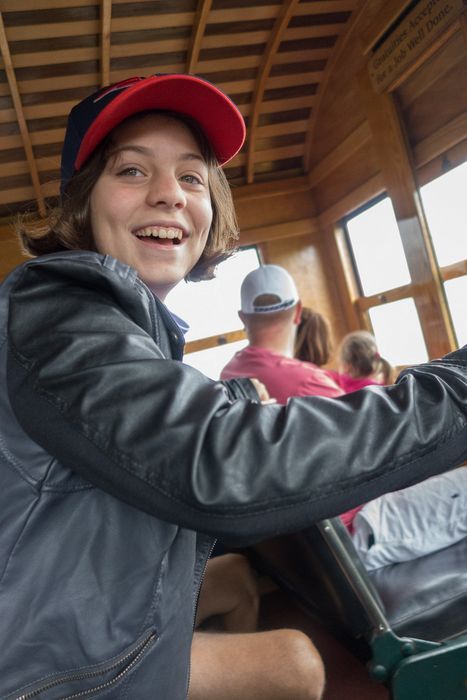 Miranda standing vertical yet at an angle to the car.<br />Aug. 22, 2014 - Cog Railway, Mount Washington, New Hampshire