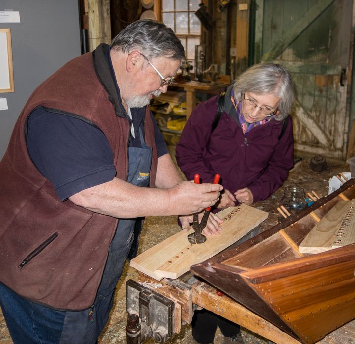 Joyce being given a rivetting demo.<br />Pre-Christmas open house.<br />Dec. 6, 2014 - Lowell's Boat Shop, Amesbury, Massachusetts.