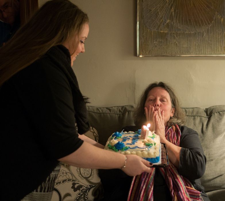 Daughter Kelly briging cake to Kathie.<br />Kathie's 60th birthday celebration.<br />Dec. 13, 2014 - At Ron and Kathie's in Merrimac, Massachusetts.