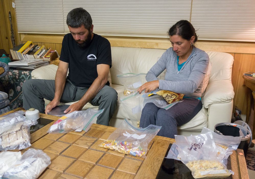 Sati and Melody packing food into bear-proof containers for the next leg of their trek.<br />Aug. 1, 2014 - White Horse Inn, Mammoth Lakes, California.