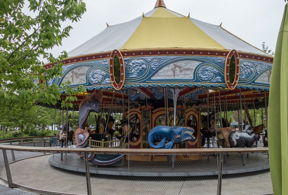 Carousel with figures fabricated by artist Jeff Briggs of Newburyport.<br />June 16, 2015 - Along the Greenway in Boston, Massachusetts.