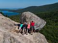 Bubble Rock on South Bubble (and some tourists posing for a photograph).<br />Sept. 17, 2015 - Acadia National Park, Mt. Desert Island, Maine.