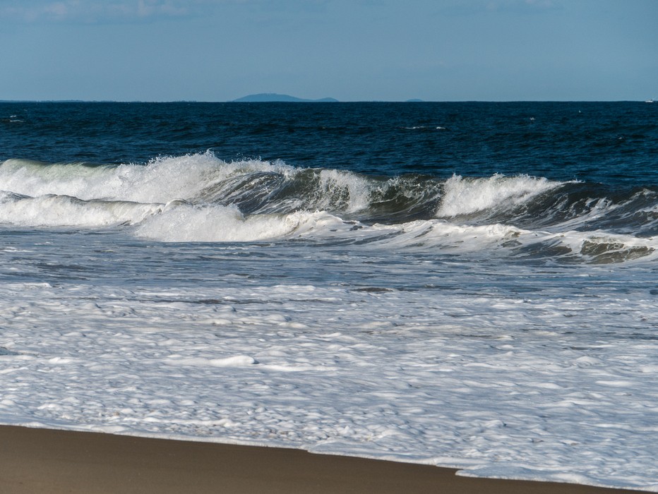 Wave with Mt. Agamenticus over the horizon.<br />Sep. 24, 2015 - Parker River National Wildlife Refuge, Plum Island, Massachusetts.