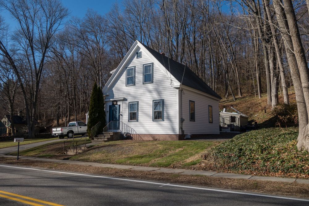The sign is in the sidewalk in front of this house on River Road.<br />Nov. 29, 2015 - Merrimac, Massachusetts.