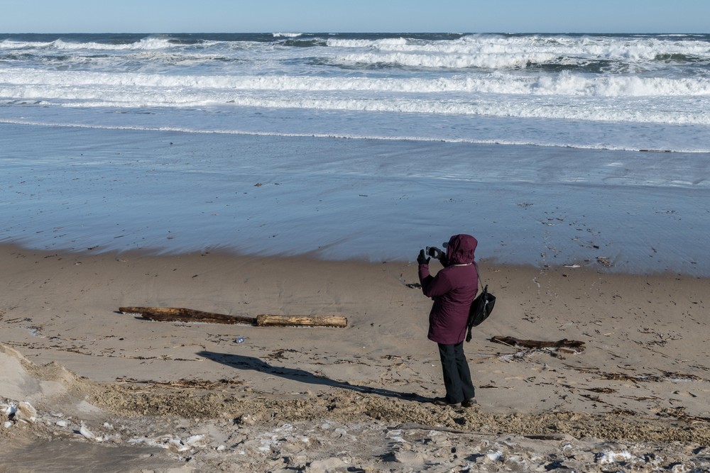 Joyce photographing the surf.<br />Jan. 24, 2016 - Parker River National Wildlife Refuge, Plum Island, Massachusetts.