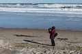 Joyce photographing the surf.<br />Jan. 24, 2016 - Parker River National Wildlife Refuge, Plum Island, Massachusetts.