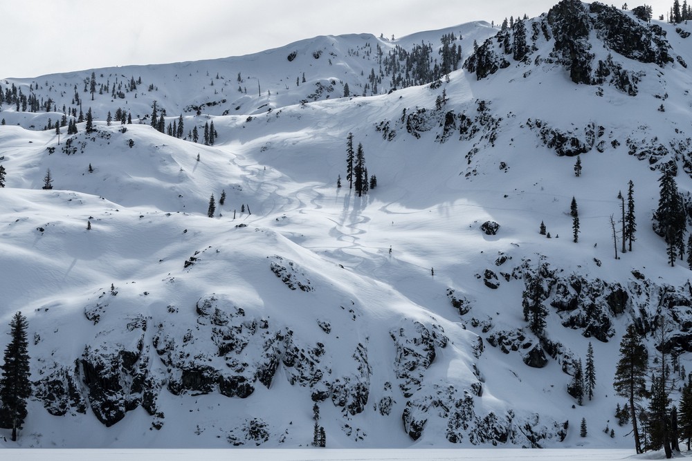 Snowboarder tracks above the lake.<br />Feb. 20, 2016 - Castle Lake, Northern California.