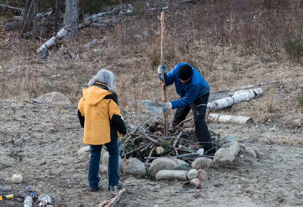 Joyce and Michael building a bonfire as part of the vernal equinox festivities.<br />March 19, 2016 - At Michael and Kathleen's in Campton, New Hampshire.