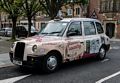 A taxi near St Peter's Bethnal Green church.<br />May 22, 2016 - London, England.