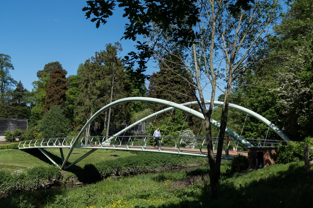 Pedestrian bridge at entrance to park.<br />May 23, 2016 - Painshill Park, Cobham, Surrey, England.