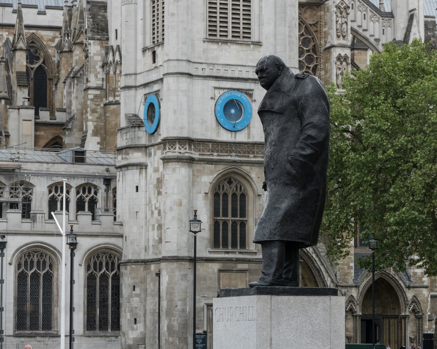 Statue of Churchill with Westminster Abbey in back.<br />May 24, 2016 - London, UK.