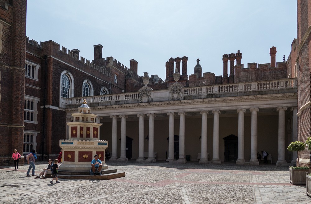 The Colonnade and a fountain in the Clock Court.<br />Hampton Court Palace.<br />May 27, 2016 - East Molesey, Surrey, UK