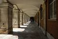 Passage (colonnade, arcade?) along Fountain Court.<br />Hampton Court Palace.<br />May 27, 2016 - East Molesey, Surrey, UK