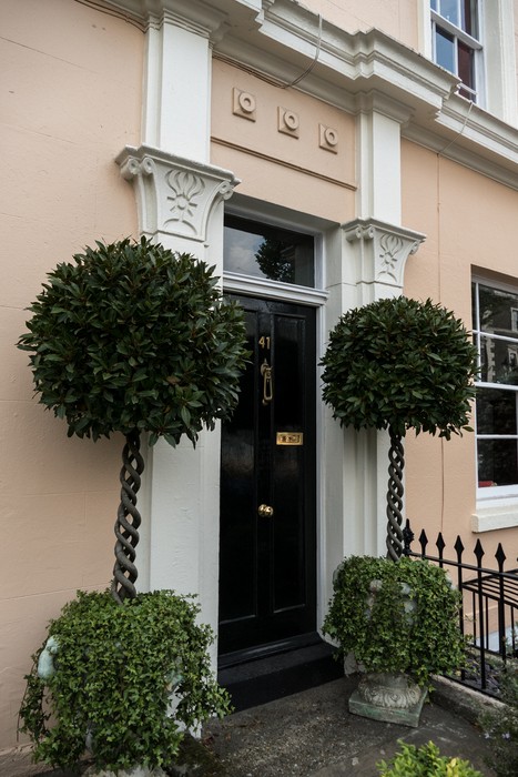 Topiary flanked door.<br />May 28, 2016 - Greenwich, UK.