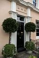 Topiary flanked door.<br />May 28, 2016 - Greenwich, UK.