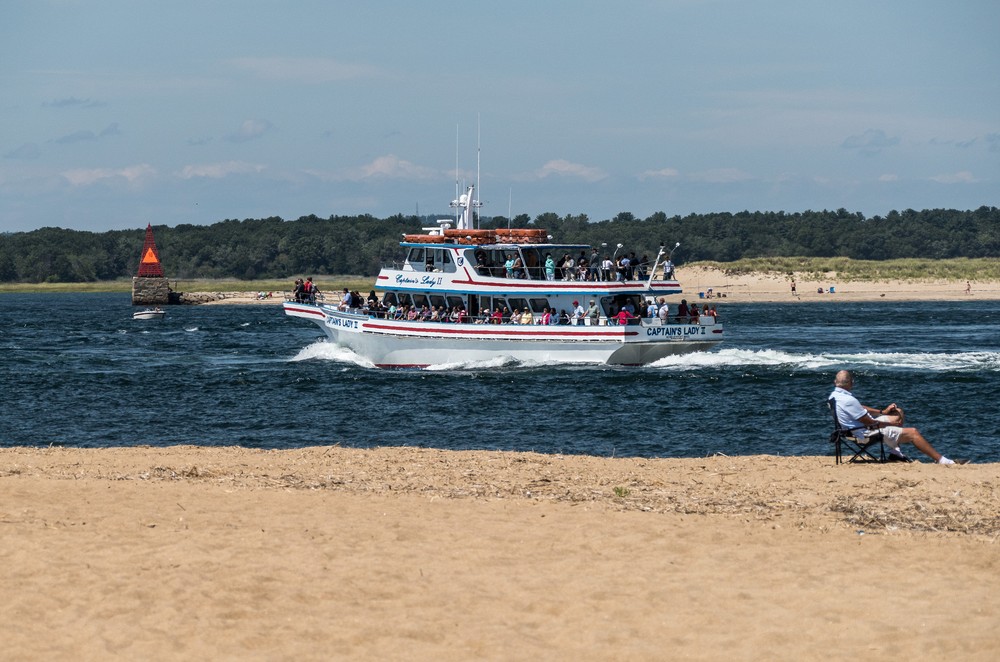 Ben Buttler's Toothpick and a whale watch boat on the Merrimack, River.<br />August 21, 2016 - North end of Plum Island, Massachusetts.
