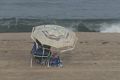 Woman under tattered umbrella.<br />Sept. 8, 2016 - Parker River National Wildlife Refuge, Plum Island, Massachusetts.