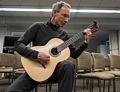 Oscar playing one of his guitar's that now belongs to George Attison.<br />Oct. 23, 2016 - Public Library, Hingham, Massachusetts.