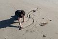 Miranda drawing in the sand.<br />Feb. 24, 2017 - Crane Beach, Ipswich, Massachusetts.