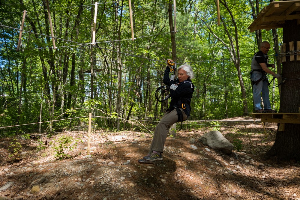Joyce zip lining with Carl next in line.<br />May 21, 2017 - Tree Top Adventures in Canton, Massachusetts.
