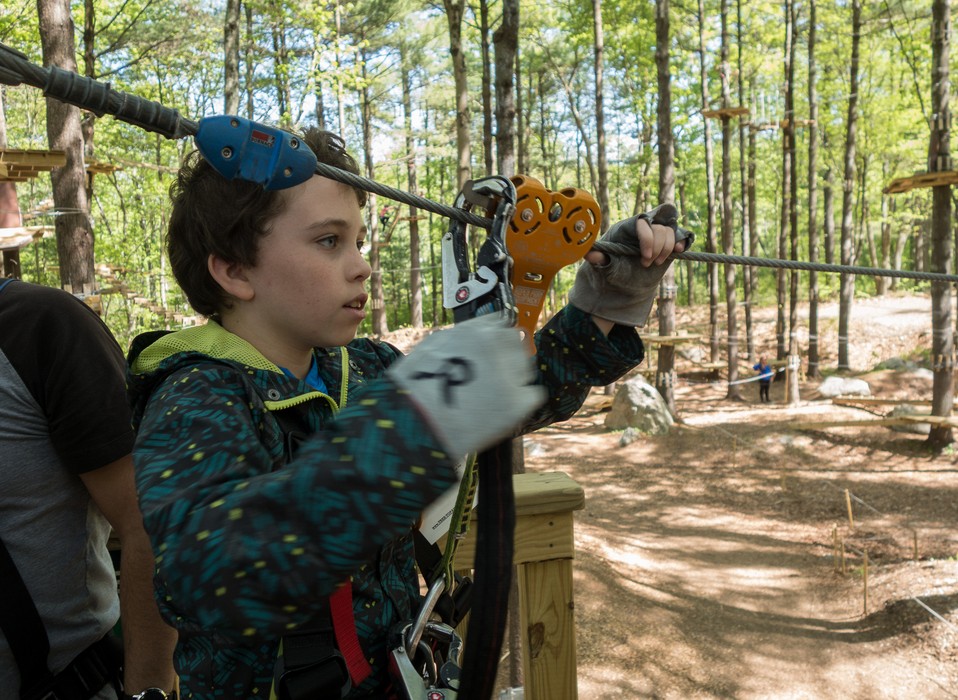 Matthew adjusting the gear for a zip line ride.<br />May 21, 2017 - Tree Top Adventures in Canton, Massachusetts.