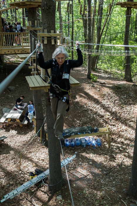 Joyce navigating a cable between two platforms.<br />May 21, 2017 - Tree Top Adventures in Canton, Massachusetts.