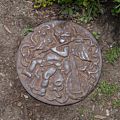 A metal medallion in the ground in Goodwin Garden.<br />June 26, 2016 - Strawbery Banke, Portsmouth, New Hampshire.
