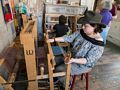 Matthew and Miranda doing some weaving while Joyce watches.<br />June 26, 2016 - Strawbery Banke, Portsmouth, New Hampshire.