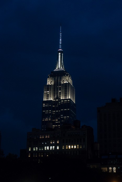 Top of the Empire State Building seen from Bryant Park.<br />July 12, 2017 - Manhattan, New York City, New  York.