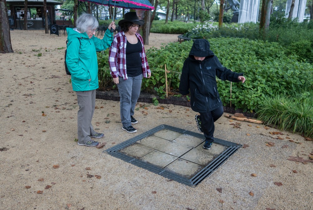 Joyce watching Miranda and Matthew play on the musical tiles.<br />July 13, 2017 - Manhattan, New York City, New  York.