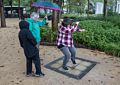Joyce watching Miranda and Matthew play on the musical tiles.<br />July 13, 2017 - Manhattan, New York City, New  York.