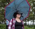 Miranda doing a balancing act with her unbrella.<br />Battery Park.<br />July 13, 2017 - Manhattan, New York City, New  York.
