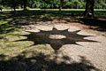 Shadow of 'Mandala' by Beth Proli-Quinn & Cailla Quinn.<br />Maudslay Outdoor Sculpture show installation.<br />Sep. 9, 2017 - Maudslay State Park, Newburyport, Massachusetts.