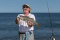 A fisherman with a 24" striped bass, which he released since it was below the minimum of 28".<br />Sept. 11, 2017 - Parker River National Wildlife Refuge, Plum Island, Massachusetts.