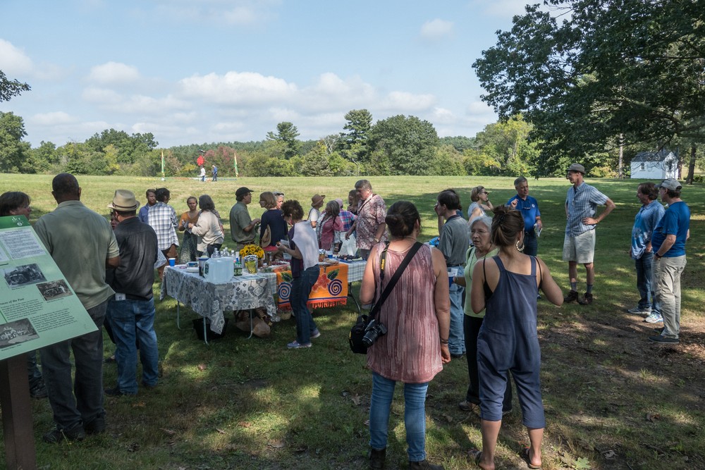 Joyce among the artists and guests at the goodies table area.<br />Outdoor Art Show opening and walk through.<br />Sept. 16, 2017 - Maudslay State Park, Newburyport, Massachusetts.
