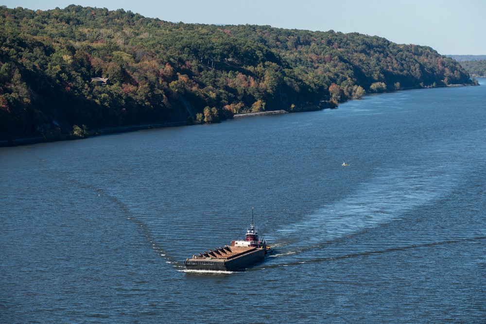 Tugboat pushing barge on the Hudson River.<br />Oct. 20, 2017 - On the Poughkeepsie-Highland bridge, New York.