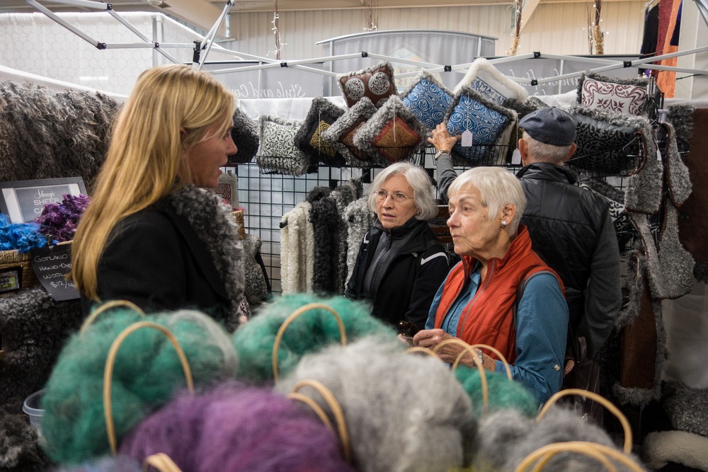 Baiba talking to the Swedish wool lady while Joyce and Ronnie stand by.<br />Sheep & Wool Festival.<br />Oct. 21, 2017 - Rhinebeck, New York.
