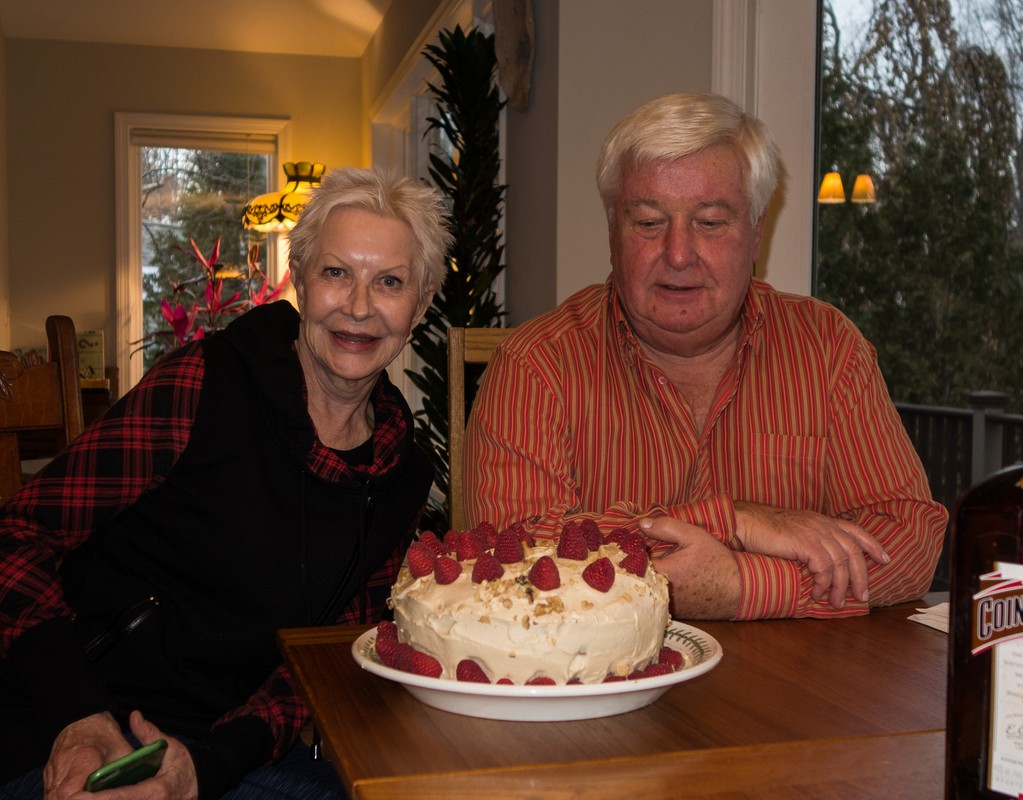 Cake made by Priscilla for Lilita's birthday. Her brother John making sure he gets a piece.<br />Dec. 2, 2017 - At John and Priscilla's in Newmarket, New Hampshire.