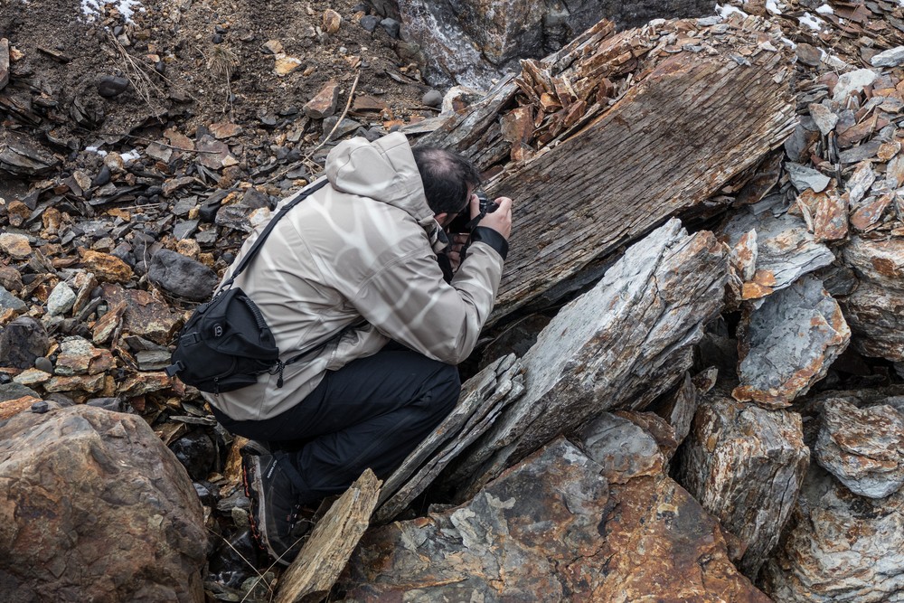 Eric photographing a rock.<br />A second hike along the Syri-Hvamms.<br />April 20, 2017 - Hvammstangi, Iceland.
