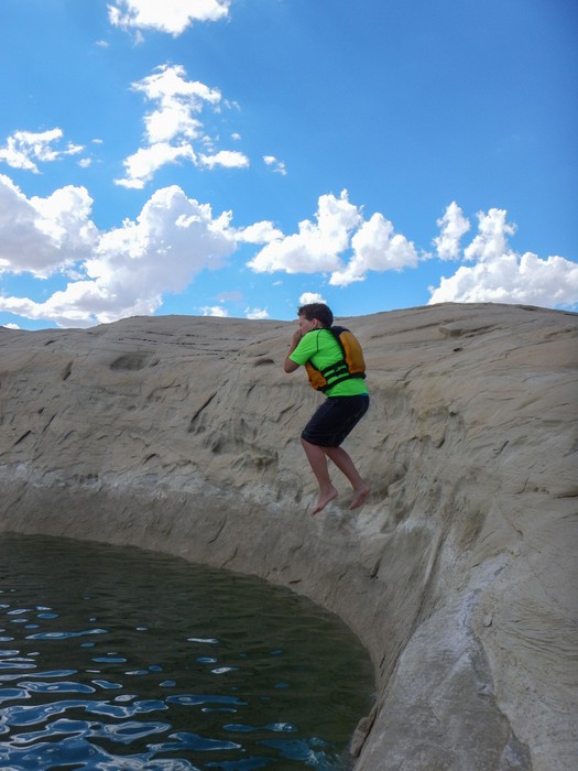 Matthew jumping.<br />Kayaking with Lake Powell Hidden Canyon Kayak off Lone Rock Beach.<br />Aug. 10, 2017 - Lake Powell, Utah.
