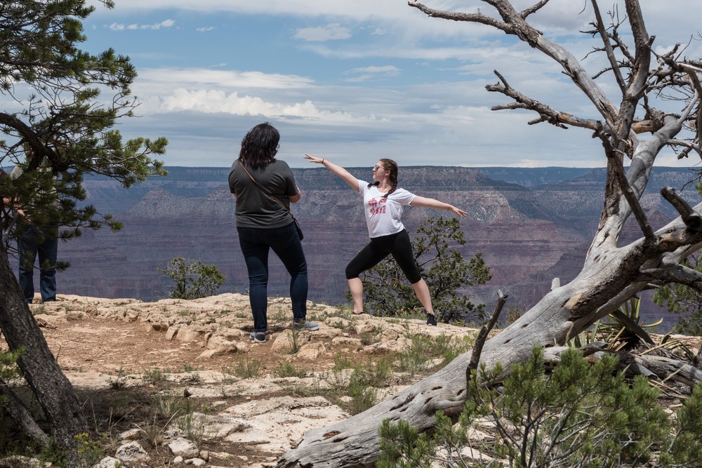 Tourist posing for a photo.<br />Along the Rim Trail.<br />Aug. 12, 2017 - Grand Canyon National Park, Arizona.