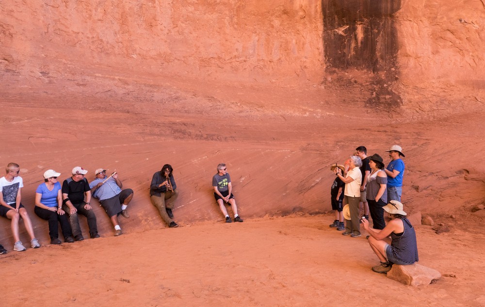 We are all listening to Sean play the other guide's double recorder.<br />On tour with Navajo Spirit Tours.<br />Aug. 14, 2017 - Monument Valley Navajo Tribal Park, Arizona.