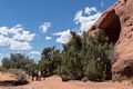 Carl, Sean, Holly, Miranda, Joyce, and Matthew looking at a big hole in the rock (it has some Anasazi structures inside)).<br />On tour with Navajo Spirit Tours.<br />Aug. 14, 2017 - Monument Valley Navajo Tribal Park, Arizona.