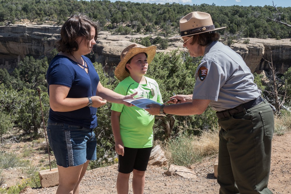 The ranger hands Miranda and Matthew their Junior Ranger badges and certificates.<br />Aug. 16, 2017 - Mesa Verde National Park, Colorado.