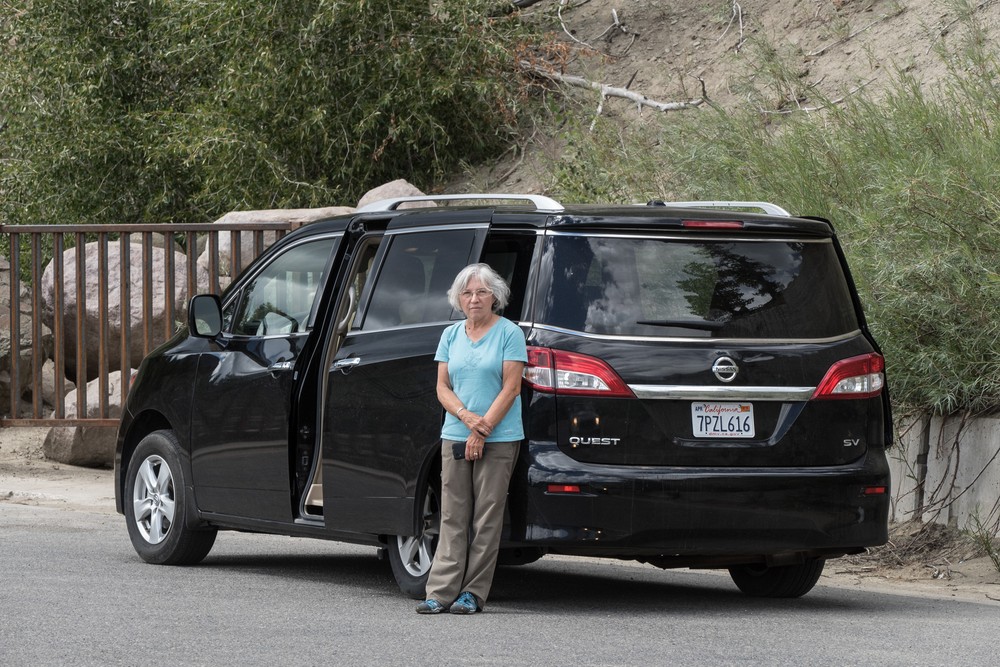 Joyce next to our rental car.<br />Aug. 17, 2017 - Wolf Creek Pass Overlook on US-160, Colorado.