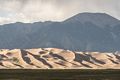 View of dunes of the Great Sand Dunes National Park with Sangre de Cristo mountains in back.<br />Aug. 17, 2017 - Great Sand Dunes Lodge, Mosca, Colorado.