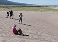 Joyce about to sled down the dune while Carl records the event.<br />Aug. 18, 2017 - Great Sand Dunes National Park, Colorado.