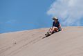 Holly's turn to try out the sand sled.<br />Aug. 18, 2017 - Great Sand Dunes National Park, Colorado.