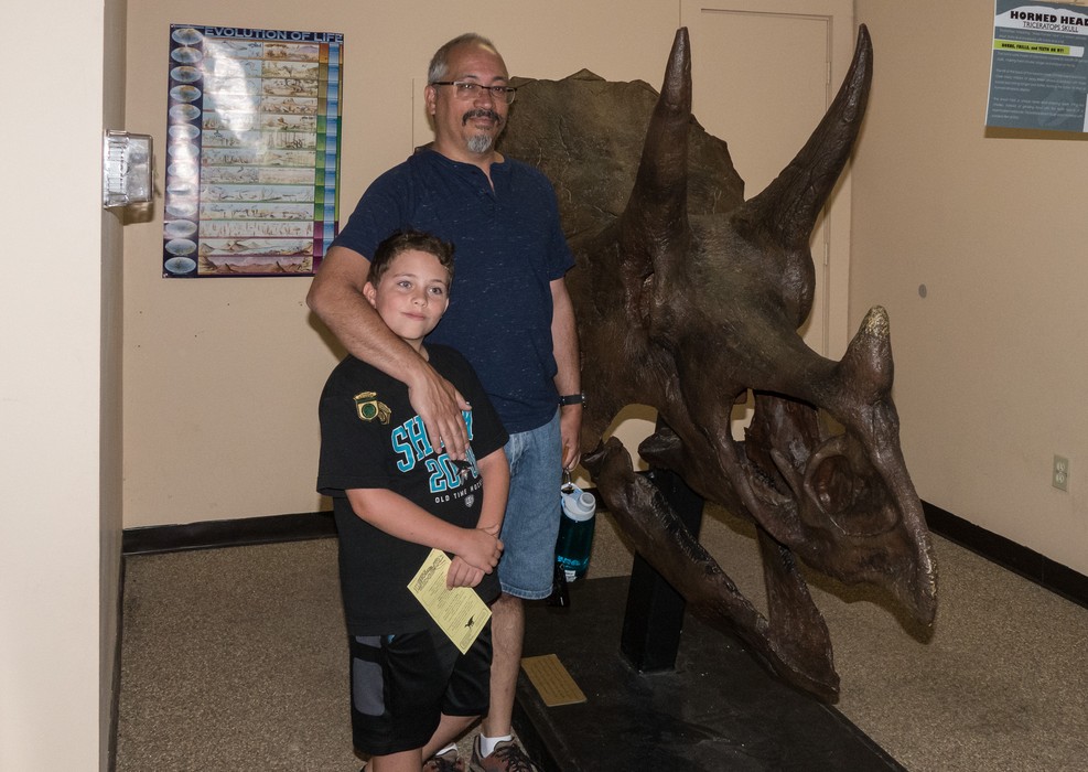 Matthew and Carl and horned skull of a triceratops.<br />Dinosaur Ridge.<br />Aug. 19, 2017 - Morrison, Colorado.